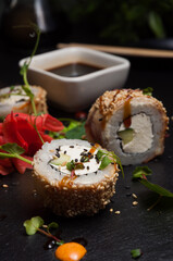sushi rolls with eel, cream cheese, cucumber and sesame