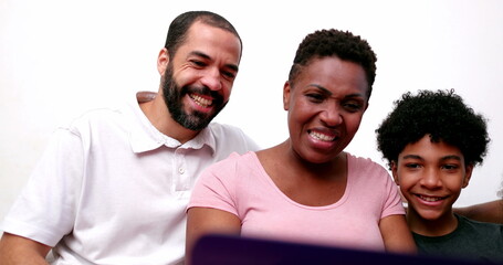 Obraz premium Happy African family talking to relatives on laptop computer