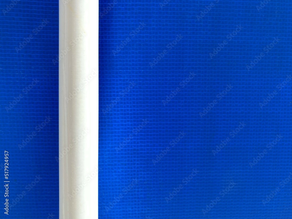 Wall mural a white round bar in front of a blue background