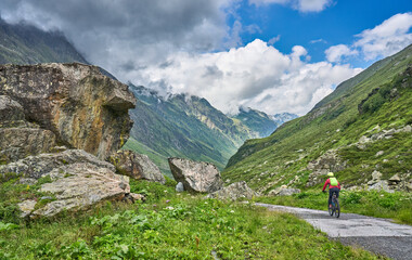 Fototapeta na wymiar nice active senior woman riding her electric mountain bike in the silvretta mountain range near Gaschurn, Tyrol, Austria