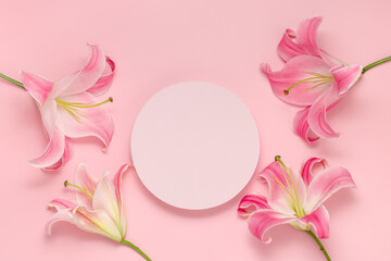 Empty round podium with flowers top view on pink background. Showcase with lily flower for product...