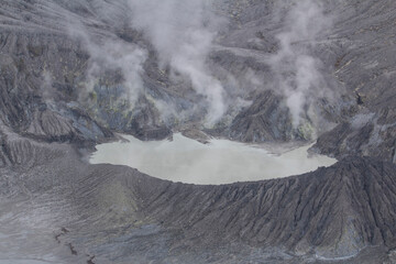 sulfur fuming volcanic crater where volcanic gases flow