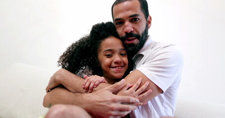 Fototapeta premium Father embracing daughter child. Interracial parent and child relationship