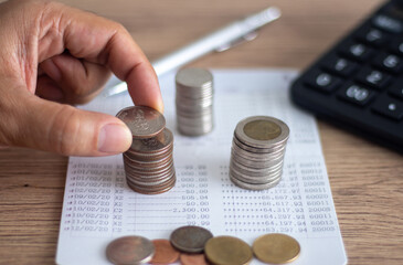 hand putting coin on book money saving ideas