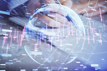Fototapeta na wymiar A woman hands writing information about stock market in notepad. Forex chart holograms in front. Concept of research. Multi exposure