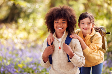 Obraz premium Portrait Of Two Children Walking Through Bluebell Woods In Springtime Together