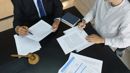 Lawyer and legal concept, Businessman signs contract after senior lawyer explains details in office