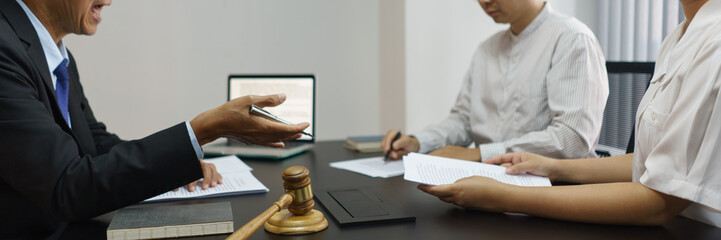 Concept of lawyer counseling, Senior lawyer provides advice to couple about their divorce agreement
