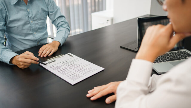 Recruitment concept, Male employer listening and consider profile and work experience of applicant