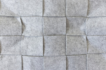 Abstract gray felt background. Home storage basket made of soft grey felt material. Surface of felted wool fabric texture. Close-up, square pattern