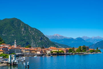 The town of Menaggio with its lakefront, its buildings, and the pier.
