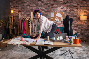 Loft tailoring atelier crazy dressmaker dancing and get excited at her workplace she take the measure and start to measurement the dress