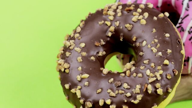 Donuts on a green background. Closeup