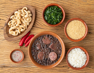 Typical brazilian feijoada with rice, kale, farofa and cracklings