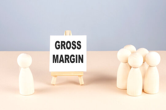 GROSS MARGIN text on easel with wooden figure, meeting concept