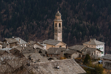The village of soglio, with the swiss alps in the background, during a winter day - march 2022.