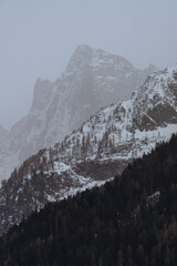 The village of soglio, with the swiss alps in the background, during a winter day - march 2022.