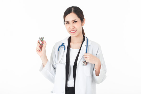 A picture of a confident Asian woman doctor and her right hand showing a bottle of medicine. And her left hand held a stethoscope on a white background.