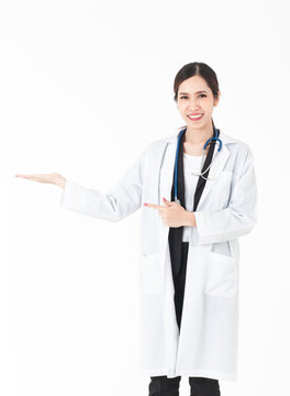 A picture of a confident Asian woman doctor presenting and showing copy space for product or text.Multiracial Asian / Caucasian female medical professional isolated on a white background.
