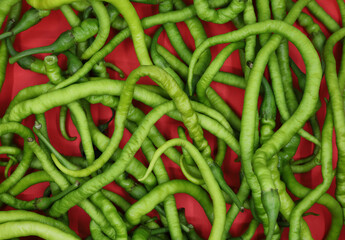 green peppers on a red background