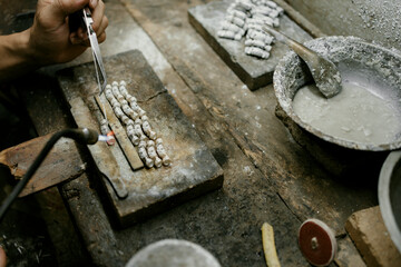 Jeweler at work in jewelry. Desktop for craft jewelry making with professional tools. Close up view of tools. Silver jewelry. Unique local artwork in Nan Province northern thailand