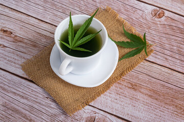 Fresh cannabis smoothie on wooden background. Concept edibles CBD and drinks with cannabis, hemp..