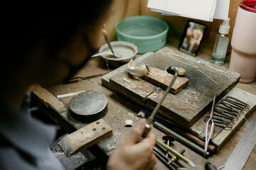 Jeweler at work in jewelry. Desktop for craft jewelry making with professional tools. Close up view of tools. Silver jewelry. Unique local artwork in Nan Province northern thailand