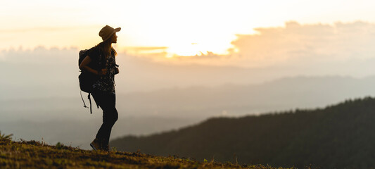 silhouette of a woman carrying a backpack for a hike adventure concept nature tourism