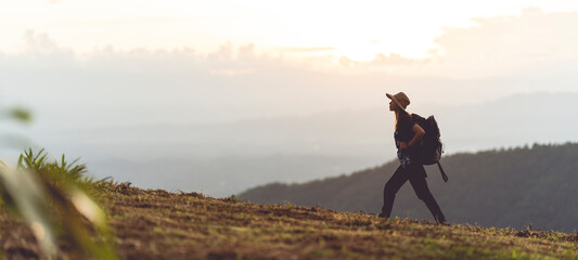 silhouette of a woman carrying a backpack for a hike adventure concept nature tourism