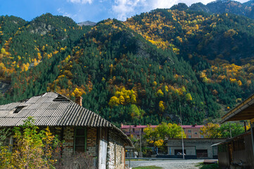 A village in the mountains. Roofs of houses in a mountain village. Autumn landscape in a mountainous area.