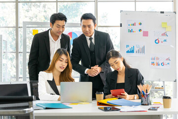 A group of young Asian businessmen Talking and planning work happily and have fun. at the company's office