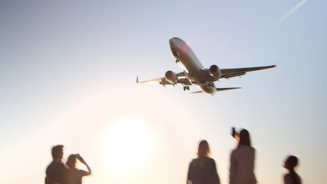 Group of people are watching to landing of plane at aircraft spotting area, 4k.