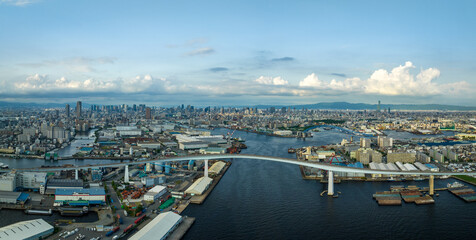 Panoramic view of bridge over river and sprawling city at sea level