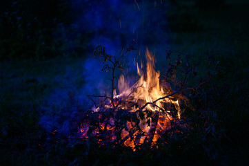 Burning apple tree branches in the fire. The custom of making a bonfire on spring holidays.