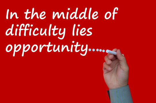 In the middle of difficulty lies opportunity text on red cover background.