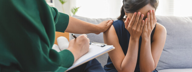 Young woman in a mental therapy session talking with a psychologist in the office.