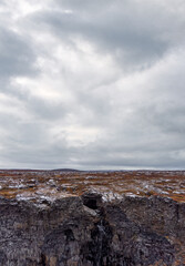 Walls surrounding spectacular Asbyrgi canyon waterfall under cloudy sky