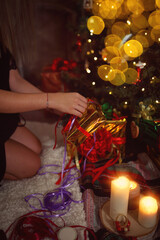 young girl wraps gifts for Christmas