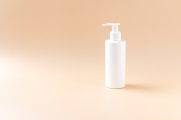 White plasstic bottle isolated on pastel color background, fluid pump container for cosmatic product, flat lay, top view.