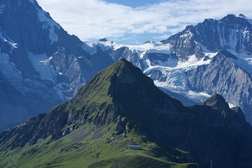 panorama of alpine peaks and  meadows in swiss alps