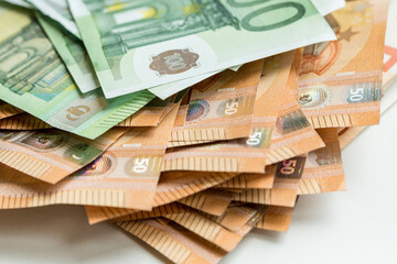 Close up view of a batch of euro currency banknotes nominated 50 and 100