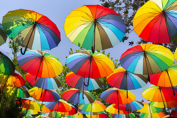 Fototapeta na wymiar Multicolored umbrellas hanging above street in Istanbul in sunny day and blue sky