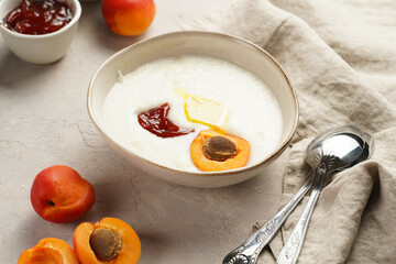 Traditional breakfast semolina porridge - creamy pudding with butter, jelly, frozen blueberries and...
