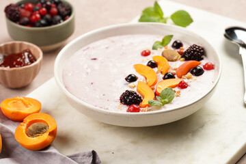 Traditional breakfast semolina porridge - purple creamy pudding with apricot slices, frozen...