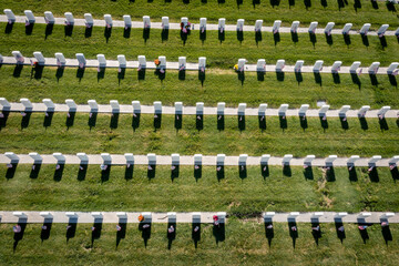 Obraz premium Drone Aerials of Military Headstones and Gravestones Decorated With Flags for Memorial Day From Above With Shadows