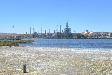 Oil Refinery with polluted Water Way - obrazy, fototapety, plakaty