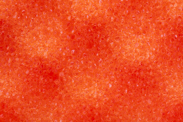 background of orange sponge washcloth closeup