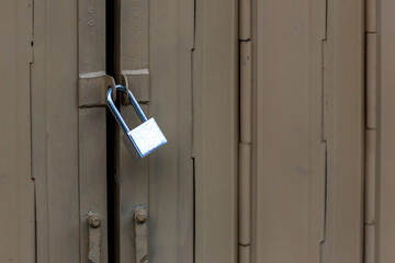Old padlock on closed doors. Door with lock. Lock on an old gate. 