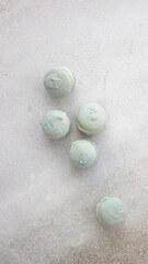 light blue macaroons on a gray stone background