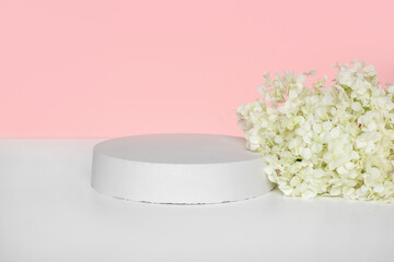 Round Podium with flowering hydrangea branches for product presentation. Abstract minimal...
